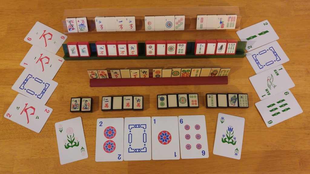 The wonderful variety of mahjong sets, including paper cards, wood, and Portland Billiard Company (the first set behind the front cards)